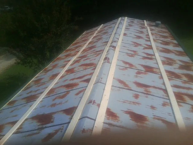 Rusted metal roof panels with new wood purlins before replacement — Storm Damage Roof Repair in Gold Hill by Roofing Brothers